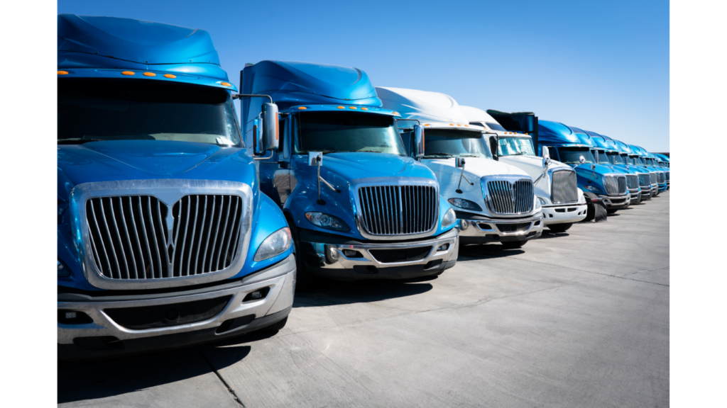 a truck fleet of blue and white heavy duty trucks waiting on maintenance 