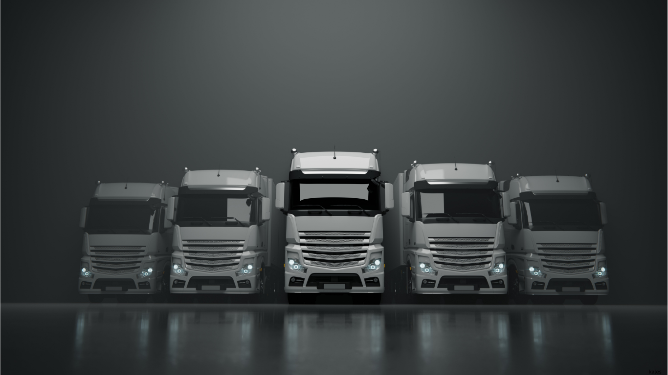 a fleet of 5 large tractor trailer trucks facing straight in shades of white and grey