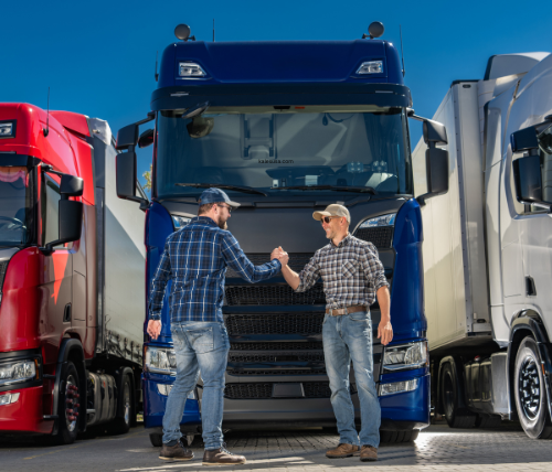 two men shaking hands in front of their reliable fleet